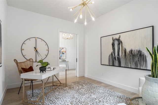 office space with wood finished floors, a notable chandelier, and baseboards