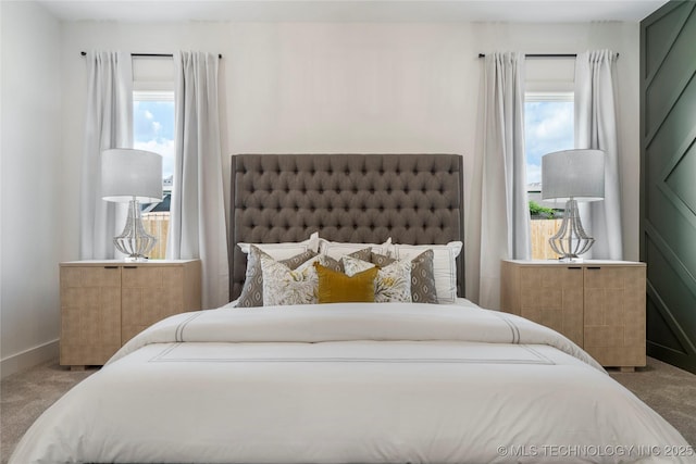 bedroom with baseboards and carpet floors