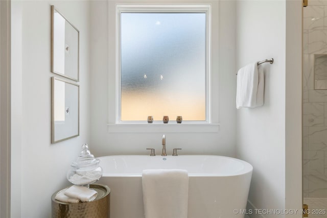 bathroom featuring a soaking tub