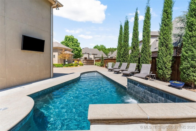 view of pool featuring a fenced in pool, a patio area, fence, and a residential view