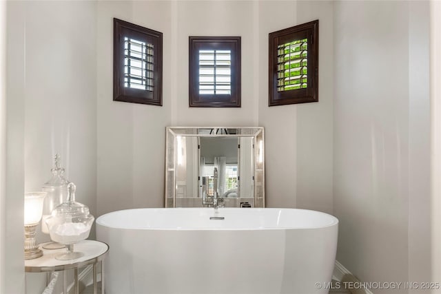 bathroom with a freestanding bath and a sink