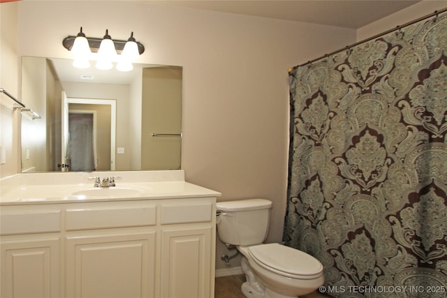 full bath featuring vanity, toilet, and tile patterned flooring