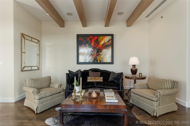 living area featuring baseboards, wood finished floors, visible vents, and beamed ceiling