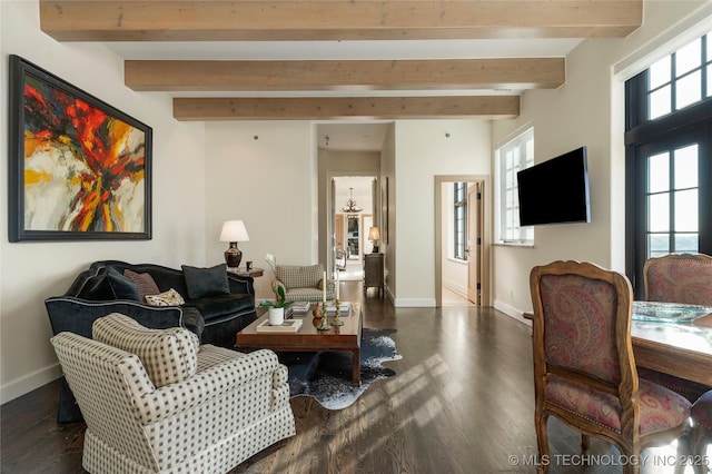 living area featuring beamed ceiling, baseboards, and dark wood-type flooring