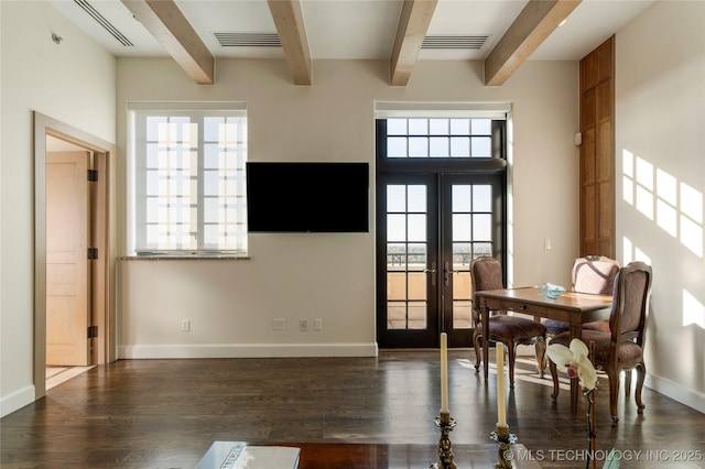 dining space featuring visible vents, beam ceiling, and wood finished floors