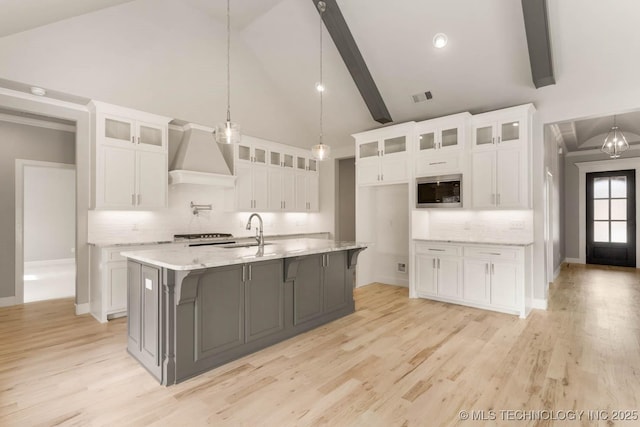 7905 N 146th E Ave, Owasso, OK 74055 - kitchen with a sink, decorative backsplash, custom range hood, and white cabinetry