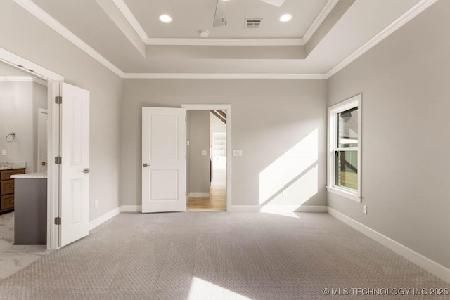 7905 N 146th E Ave, Owasso, OK 74055 - unfurnished bedroom featuring light colored carpet, baseboards, a tray ceiling, visible vents, and ornamental molding
