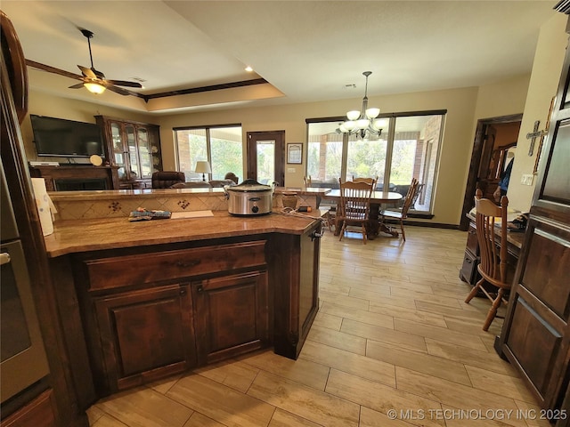 2267 Krebs Lk, Mcalester, OK 74501 - kitchen with wood counters, plenty of natural light, a chandelier, and a ceiling fan
