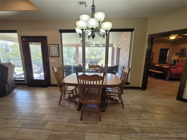 2267 Krebs Lk, Mcalester, OK 74501 - dining area with a chandelier, wood tiled floors, and baseboards