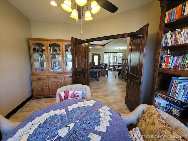 dining room featuring ceiling fan, baseboards, and light wood-style floors