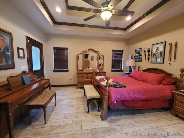 bedroom with crown molding, a raised ceiling, baseboards, and a ceiling fan