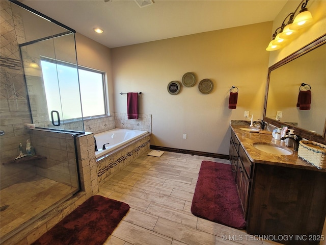 2267 Krebs Lk, Mcalester, OK 74501 - bathroom featuring a garden tub, double vanity, and a stall shower