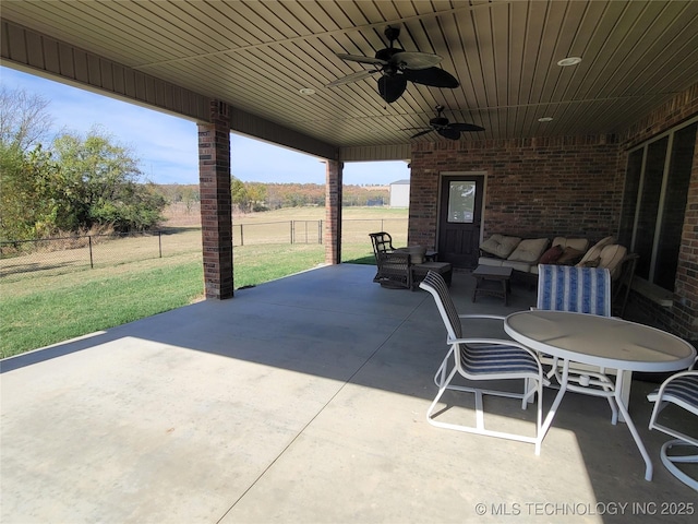 view of patio / terrace with ceiling fan, fence, and an outdoor hangout area