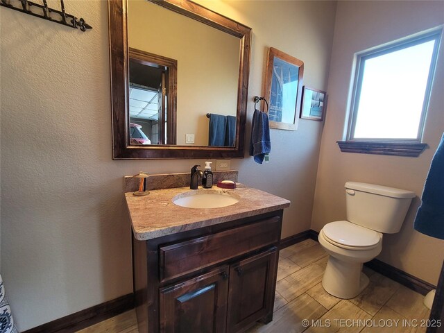 2267 Krebs Lk, Mcalester, OK 74501 - half bathroom with vanity, baseboards, and toilet