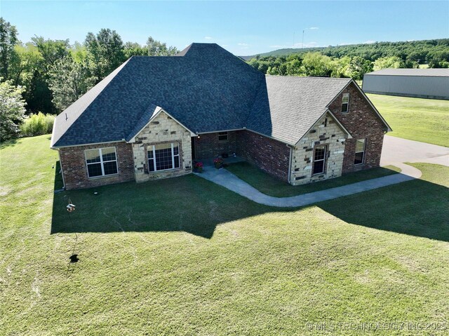 2267 Krebs Lk, Mcalester, OK 74501 - view of front facade featuring a front yard, a shingled roof, and stone siding