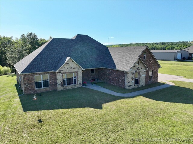 2267 Krebs Lk, Mcalester, OK 74501 - view of front of property featuring a front yard, a shingled roof, brick siding, and stone siding