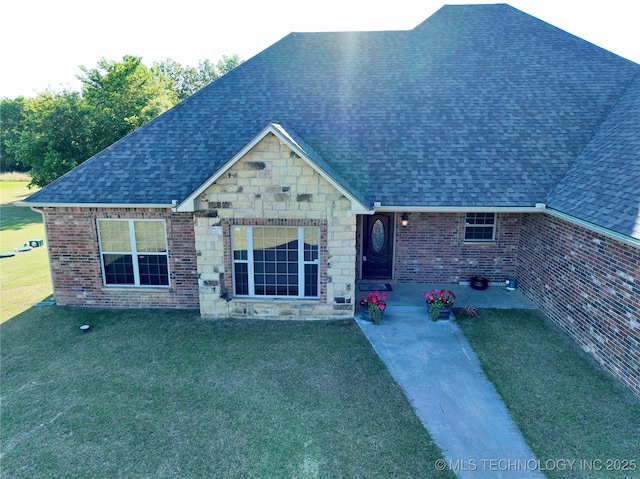 2267 Krebs Lk, Mcalester, OK 74501 - view of front of house with a shingled roof, a front lawn, stone siding, and a patio