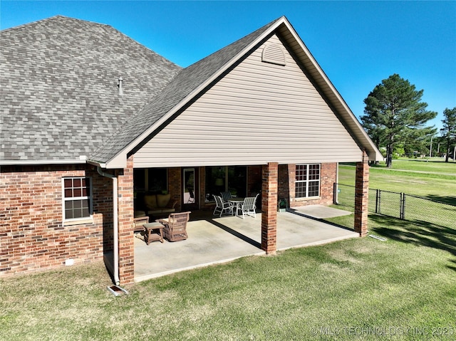 2267 Krebs Lk, Mcalester, OK 74501 - rear view of property with a shingled roof, brick siding, and a patio area