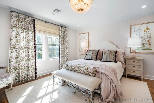 bedroom with visible vents, wood finished floors, baseboards, ornamental molding, and recessed lighting