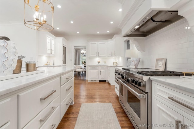 kitchen with crown molding, white cabinetry, custom exhaust hood, and double oven range