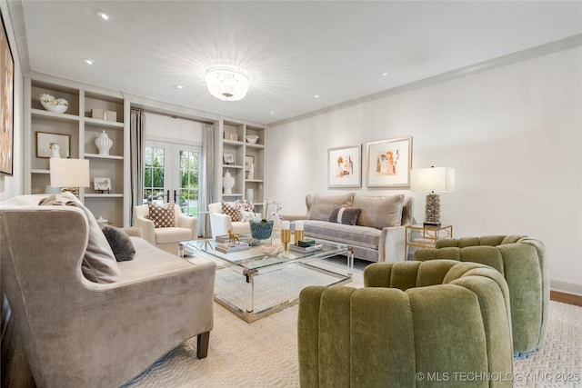 living area featuring recessed lighting, baseboards, light wood-type flooring, and built in shelves