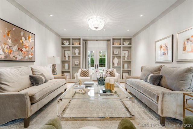 living room with ornamental molding, french doors, built in shelves, and a chandelier