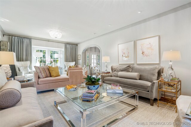 living room with arched walkways and a wealth of natural light