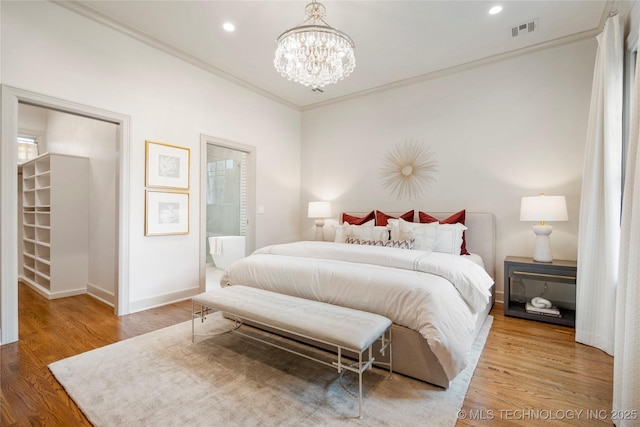 bedroom with visible vents, crown molding, an inviting chandelier, wood finished floors, and baseboards