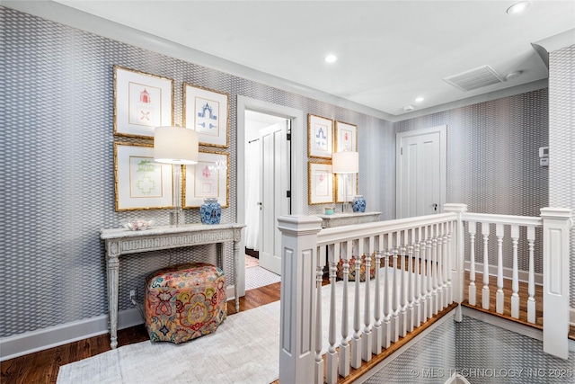 bedroom with visible vents, wood finished floors, baseboards, wallpapered walls, and recessed lighting