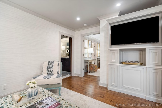 living area with crown molding, recessed lighting, baseboards, and wood finished floors