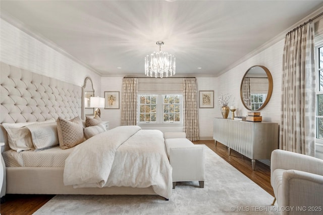 bedroom featuring crown molding, wood finished floors, a notable chandelier, and wallpapered walls
