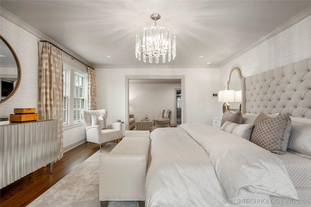 bedroom with an inviting chandelier, ornamental molding, wood finished floors, and wallpapered walls