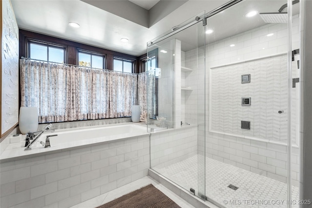 bathroom with a shower stall and a garden tub