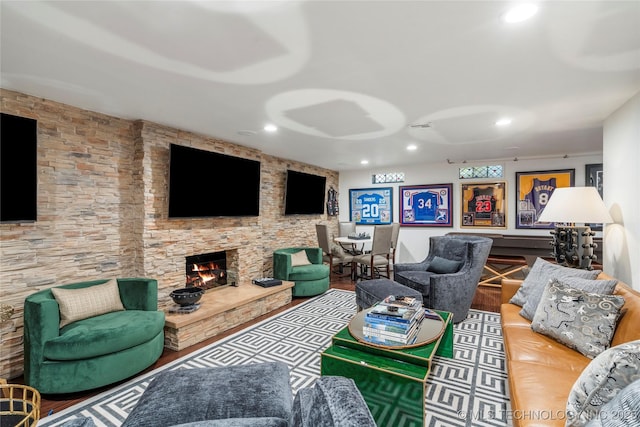 living area featuring recessed lighting, wood finished floors, and a fireplace