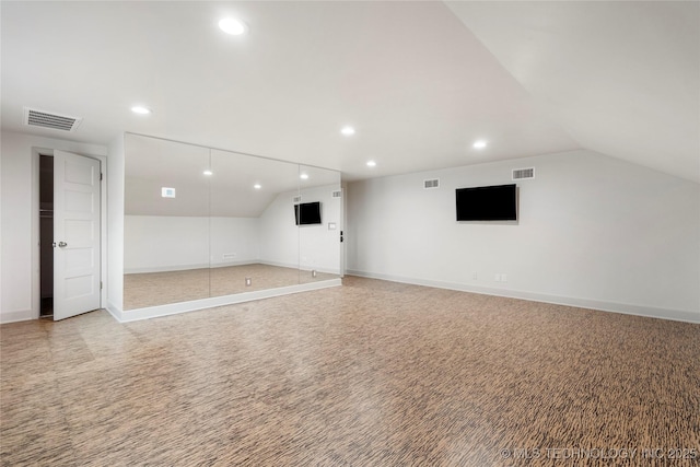 interior space with light carpet, vaulted ceiling, recessed lighting, and visible vents