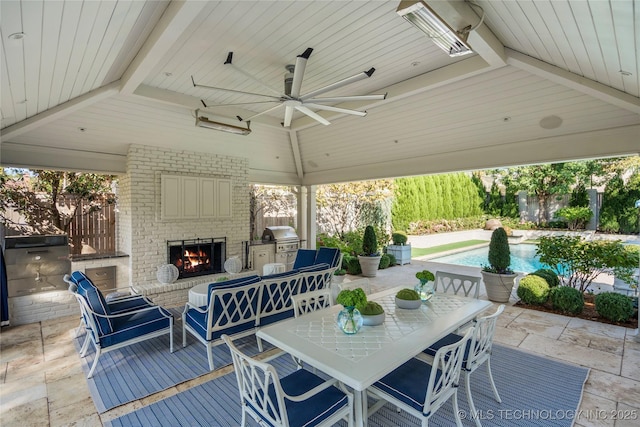 view of patio featuring grilling area, a ceiling fan, outdoor dining area, an outdoor pool, and an outdoor brick fireplace