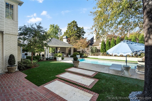 view of yard with a fenced in pool, a gazebo, and a patio area