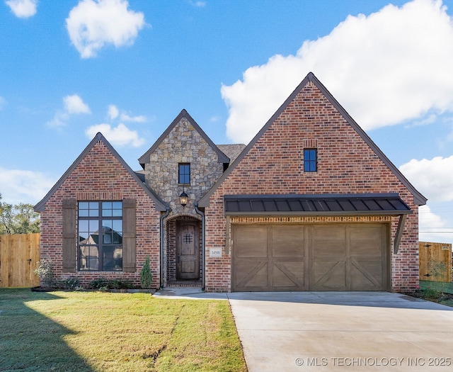 14500 E 79th St, Owasso, OK 74055 - view of front of property featuring a front lawn, fence, a standing seam roof, brick siding, and concrete driveway