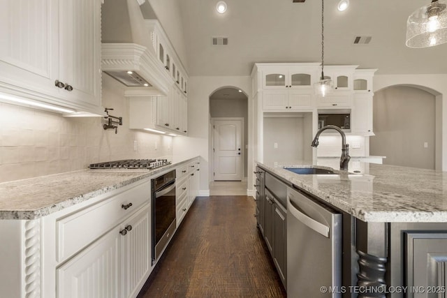 14500 E 79th St, Owasso, OK 74055 - kitchen featuring visible vents, premium range hood, arched walkways, a sink, and stainless steel appliances