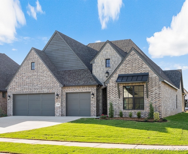 view of front facade with a front yard, roof with shingles, brick siding, an attached garage, and driveway