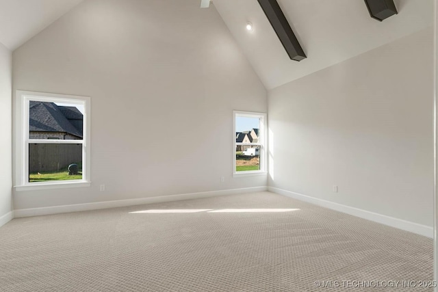 spare room with high vaulted ceiling, light colored carpet, baseboards, and beam ceiling