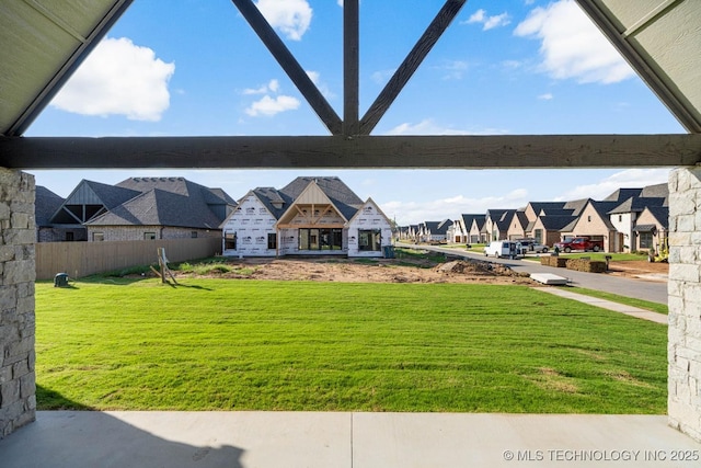 view of yard featuring a residential view and fence