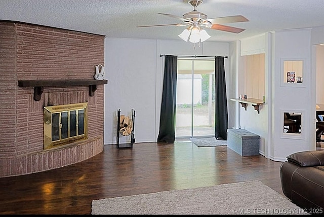 1112 N Hickory Ct, Broken Arrow, OK 74012 - living area with a ceiling fan, wood finished floors, a fireplace, and a textured ceiling