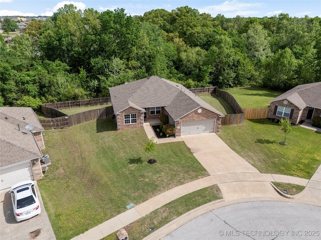 drone / aerial view featuring a wooded view