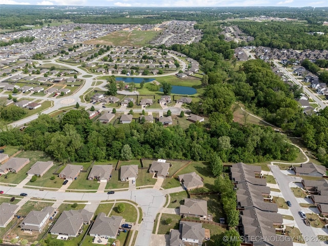 drone / aerial view with a residential view and a water view