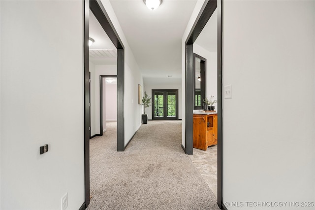 corridor with light colored carpet
