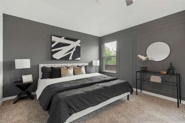 carpeted bedroom featuring baseboards