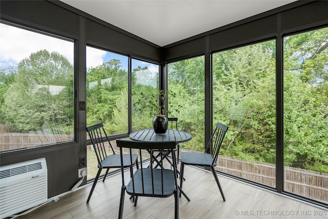 sunroom featuring an AC wall unit