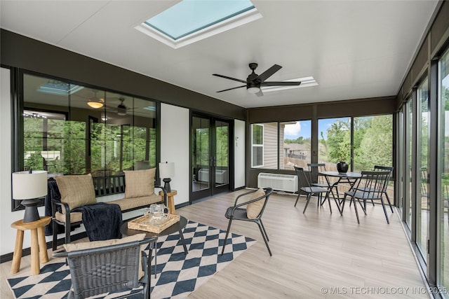sunroom featuring a ceiling fan, a skylight, french doors, and wood finished floors