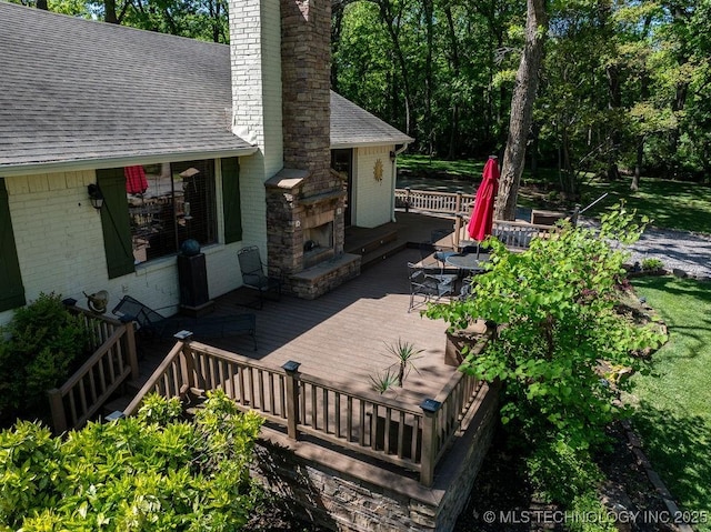 view of patio featuring a deck and an outdoor stone fireplace